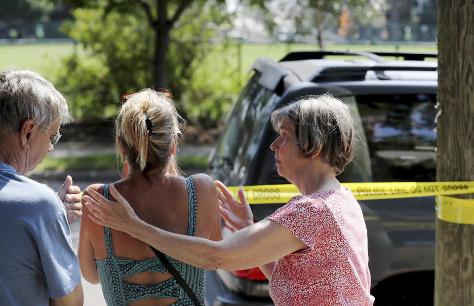 <p>Former Minnehaha Academy employees Elizabeth Van Pilsum, center, is comforted by friends Edie Olson, right, and Rick Olson, left, after an explosion at Minnehaha Academy Aug. 2, 2017, in Minneapolis. (David Joles/Star Tribune via AP) </p>