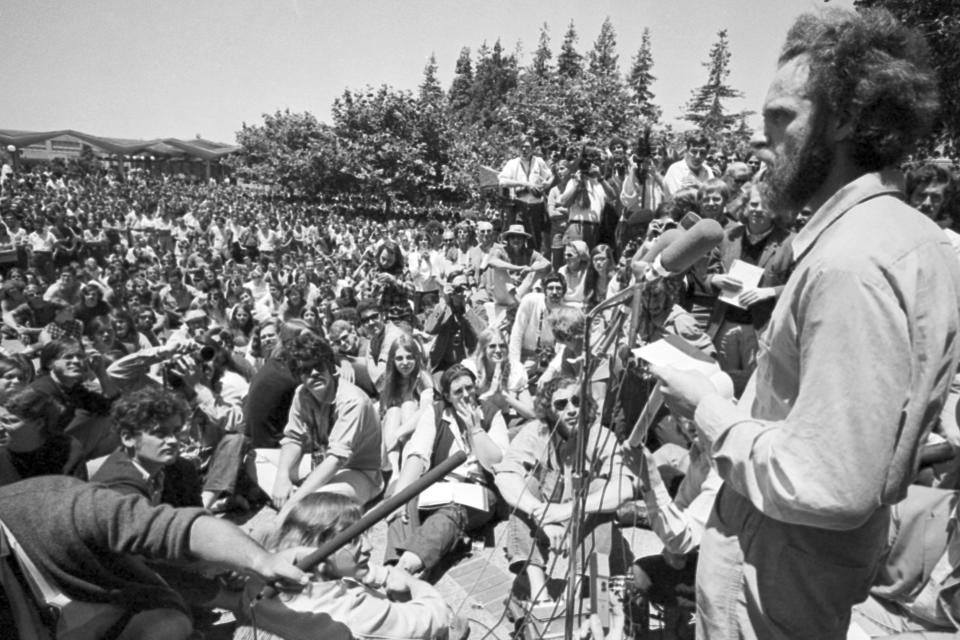 FILE - Mario Savio, right, who led the Freedom of Speech movement at the University of California, speaks at a People's Park rally on the university campus in Berkeley, Calif., June 26, 1969. The three-acre site's colorful history, forged from University of California, Berkeley's seizure of the land in 1968, has been thrust back into the spotlight by the school's renewed effort to pave over People's Park as part of a $312 million project that includes sorely needed housing for about 1,000 students. (AP Photo/Sal Veder, File)