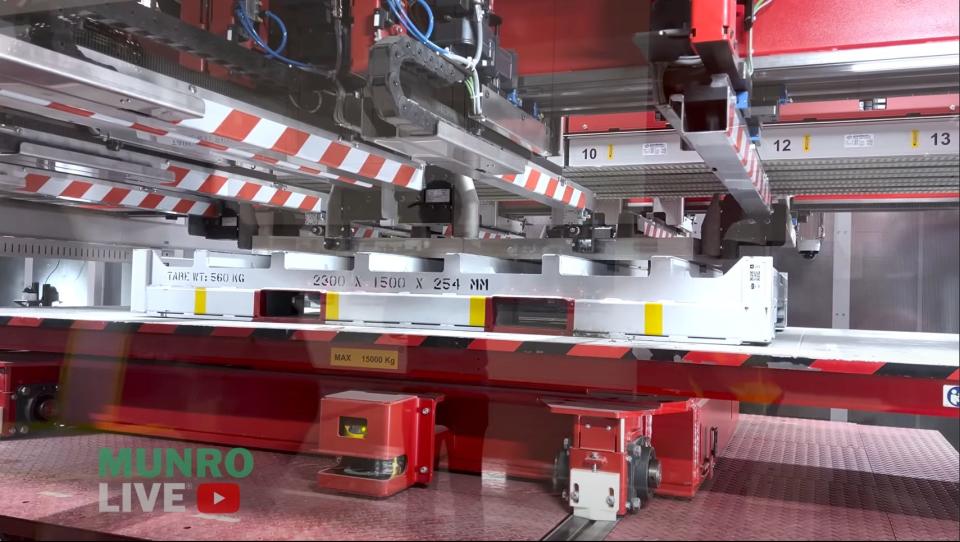 An image of a red and silver machine in the Cybertruck factory.