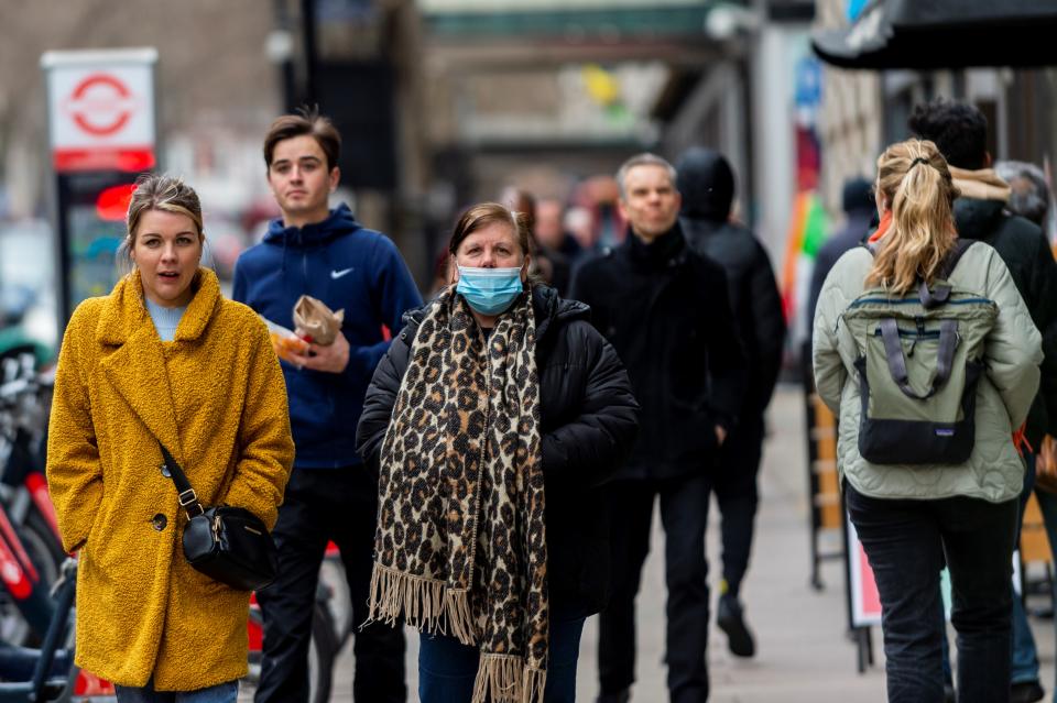 People walk in a street in London, Britain, Feb. 21, 2022.  British Prime Minister Boris Johnson announced Monday the end of all domestic COVID-19 restrictions in England in a process starting later this week.  The legal requirement for people who test positive for coronavirus to self-isolate will be removed from Thursday of this week, Johnson has announced. (Photo by Stephen Chung/Xinhua via Getty Images)