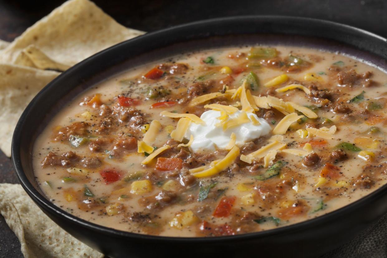 Cheesy Beef Taco Soup with Red and Green Peppers, Corn, Cheddar Cheese, Sour Cream and Tortilla Chips