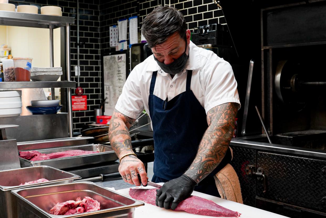 Brett Levane trims a beef tenderloin at True Blue Butcher and Table in this file photo. STAR NEWS FILE PHOTO