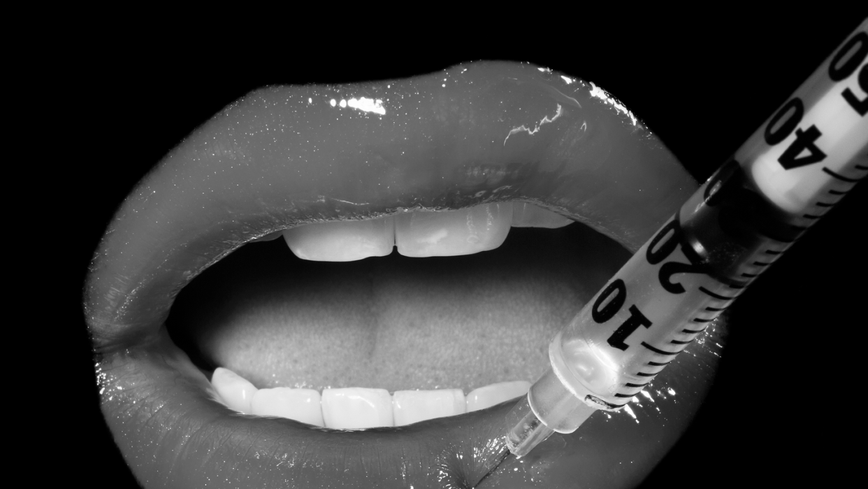 syringe being injected into lips