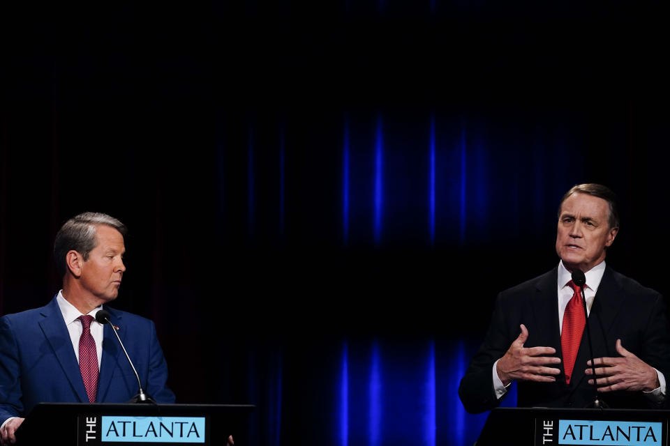 FILE - Former Sen. David Perdue, right, speaks during a gubernatorial republican primary debate toward Georgia Gov. Brian Kemp, left, on May 1, 2022, in Atlanta. Having vanquished both a Donald Trump-backed Republican challenger and Democratic star Stacey Abrams to win reelection, Kemp is looking to expand his influence in his second term, free from the caricature of the gun-toting, pickup-driving, migrant-catching country boy that emerged during his first campaign for governor.(AP Photo/Brynn Anderson, Pool, File)