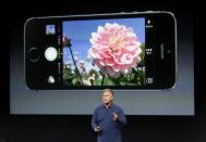 REFILE - CORRECTING NAME AND POSITION OF SPEAKER Phil Schiller, senior vice president of worldwide marketing for Apple Inc, talks about the camera in the new iPhone 5S during Apple Inc's media event in Cupertino, California September 10, 2013. REUTERS/Stephen Lam (UNITED STATES - Tags: BUSINESS SCIENCE TECHNOLOGY BUSINESS TELECOMS)