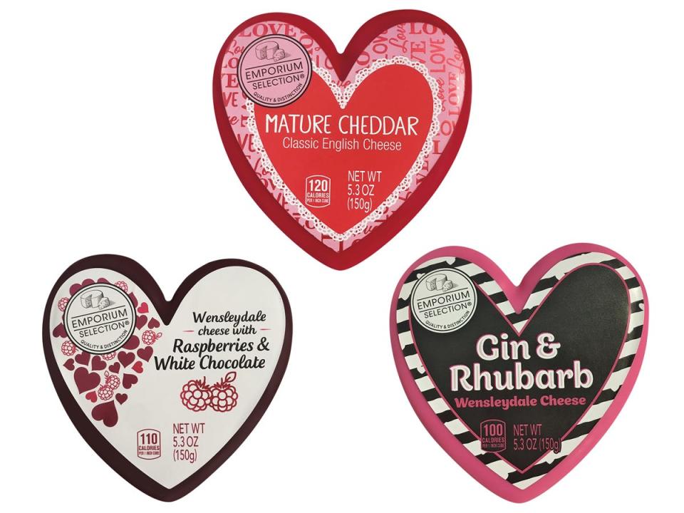 Heart-shaped packages of Emporium Selection mature cheddar, Wensleydale cheese with raspberries and chocolate, and gin-and-rhubarb Wensleydale cheese against a white background