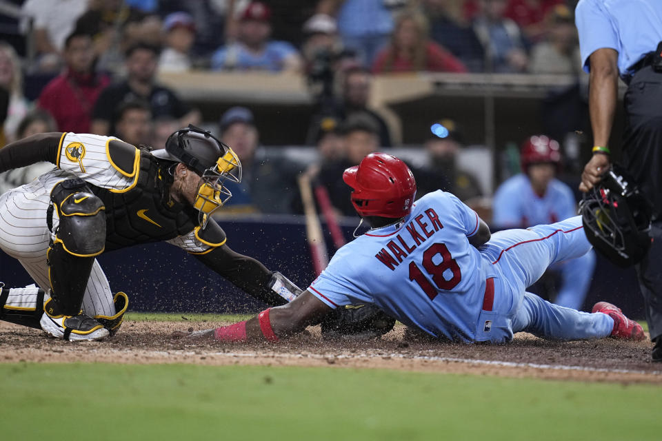 San Diego Padres catcher Luis Campusano, left, is late with the tag as St. Louis Cardinals' Jordan Walker scores off a sacrifice fly by Andrew Knizner during the eleventh inning of a baseball game Saturday, Sept. 23, 2023, in San Diego. (AP Photo/Gregory Bull)