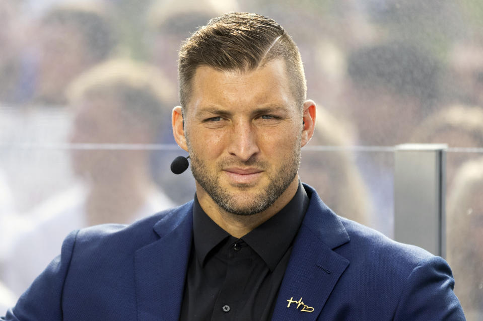 FILE - SEC Nation host Tim Tebow listens to his co-hosts during the SEC Nation broadcast in Lexington, Ky., Saturday, Oct. 9, 2021. Tebow, who won the Heisman in 2007, was elected to the College Football Hall of Fame, Monday, Jan. 9, 2023. (AP Photo/Michael Clubb, File)