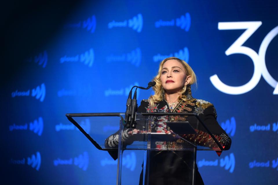 While giving a speech, beautiful Madonna captivated everyone in a black overall with gold and silver designs