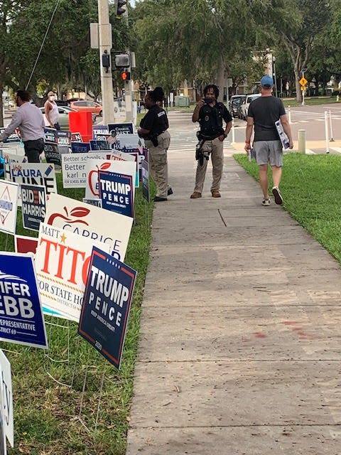 Voters say armed guards stood near an early voting site in St. Petersburg, Fla., on Oct. 21, 2020.