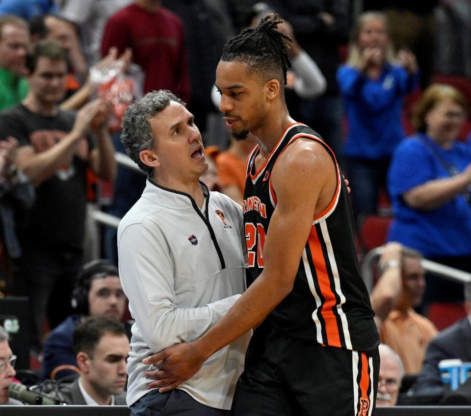 Princeton Tigers head coach Mitch Henderson talks with forward Tosan Evbuomwan during the NCAA tournament game March 24, 2023 vs. Creighton in Louisville, Kentucky.