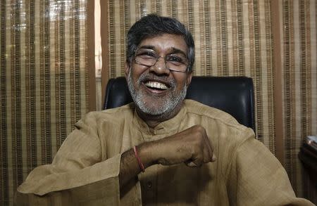 Children's right activist Kailash Satyarthi laughs at his office in New Delhi October 10, 2014. REUTERS/Adnan Abidi
