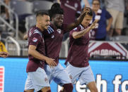 Colorado Rapids defender Lalas Abubakar, center, is congratulated on his goal by forward Andre Shinyashiki, left, and midfielder Cole Bassett during the second half of the team's MLS soccer match against FC Dallas on Wednesday, July 21, 2021, in Commerce City, Colo. The Rapids won 2-0. (AP Photo/David Zalubowski)