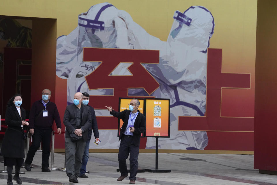 Members of the World Health Organization team including Ken Maeda, center, Peter Daszak, third from left and Vladmir Dedkov, fourth from left, leave after attending an exhibition about the fight against the coronavirus in Wuhan in central China's Hubei province on Saturday, Jan. 30, 2021. The World Health Organization team investigating the origins of the coronavirus pandemic visited another Wuhan hospital that had treated early COVID-19 patients on their second full day of work on Saturday. (AP Photo/Ng Han Guan)