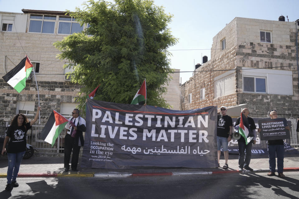 Protesters hold posters for slain Palestinian-American journalist Shireen Abu Akleh near the Augusta Victoria Hospital in east Jerusalem ahead of a visit by U.S. President Joe Biden, Friday, July 15, 2022. The protesters said they are seeking justice in the killing of Abu Akleh, who was shot dead while covering an Israeli military raid in the occupied West Bank in May. A U.S. investigation concluded that Israeli troops likely shot her, but without providing evidence, said the shooting appears to be have been unintentional. (AP Photo/Maya Alleruzzo)