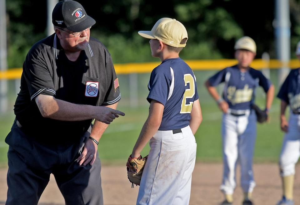 Shrewsbury relief pitcher Gino Leardi listens to stern words from the base umpire as he prepares to take the mound during the District 5 11-year-old Little League championship.

Algonquinshrewsbury 02