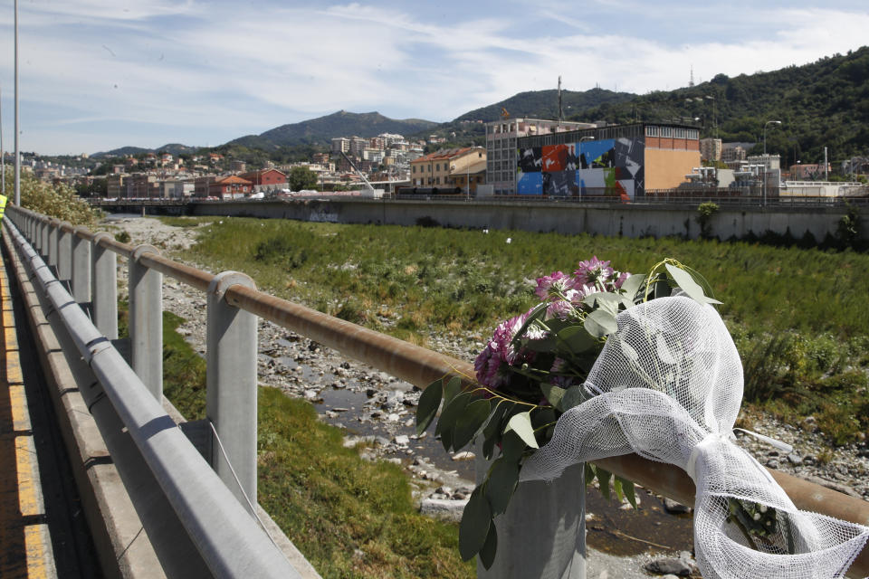 Flowers were left along the course of the Polcevera bridge during a remembrance ceremony to mark the first anniversary of the Morandi bridge collapse, in Genoa, Italy, Wednesday, Aug. 14, 2019. The Morandi bridge was a road viaduct on the A10 motorway in Genoa, that collapsed one year ago killing 43 people. (AP Photo/Antonio Calanni)