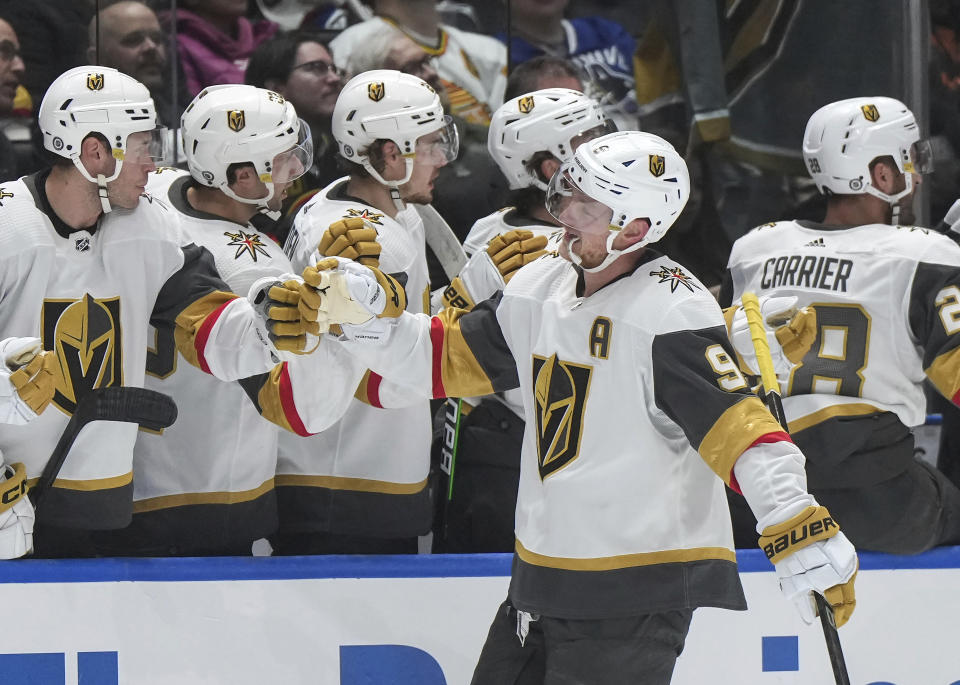 Vegas Golden Knights' Jack Eichel (9) is congratulated for a goal against the Vancouver Canucks during the first period of an NHL hockey game Thursday, Nov 30, 2023, in Vancouver, British Columbia. (Darryl Dyck/The Canadian Press via AP)