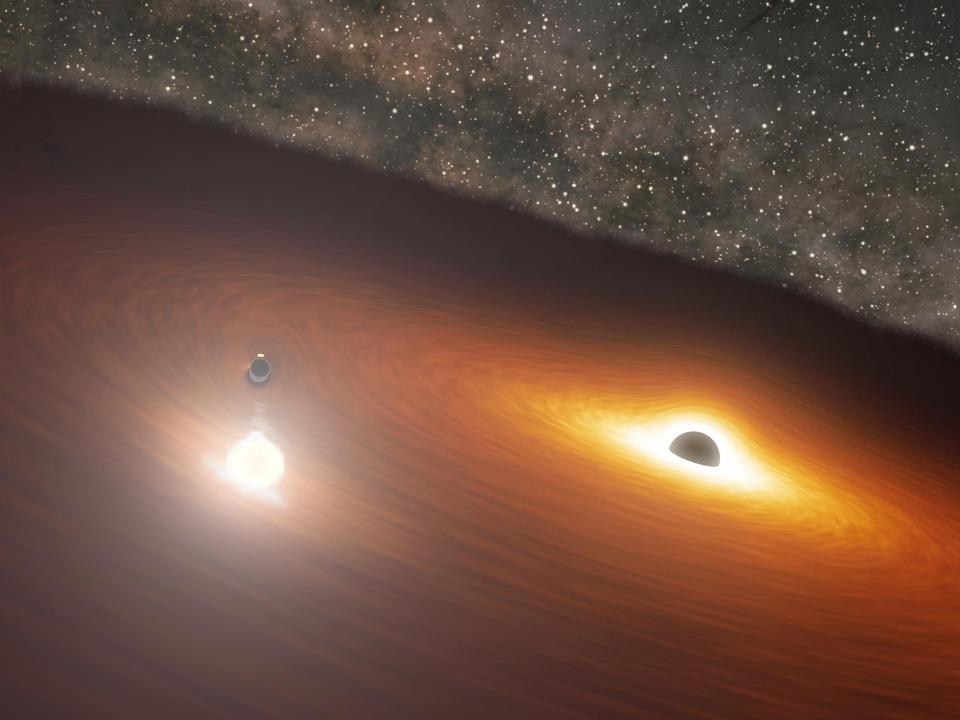 An artistic rendering of two massive black holes in the OJ 287 galaxy.