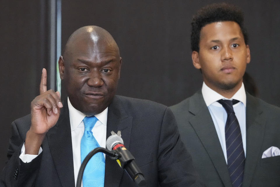 Attorney Ben Crump, left, speaks as former Northwestern quarterback Lloyd Yates, right, listens at a news conference in Chicago, Monday, July 24, 2023. A Northwestern hazing scandal includes multiple sports, men and women, attorneys have said. (AP Photo/Nam Y. Huh)