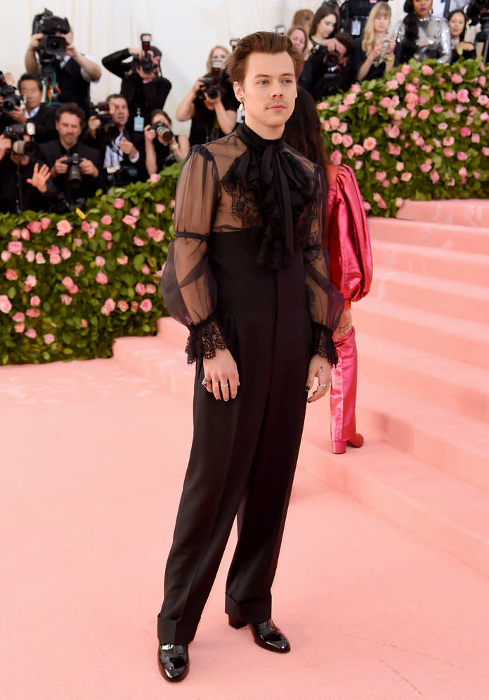 Harry Styles showed up at the Met Gala in a high-waisted Gucci jumpsuit that included a ruffled sheer blouse.