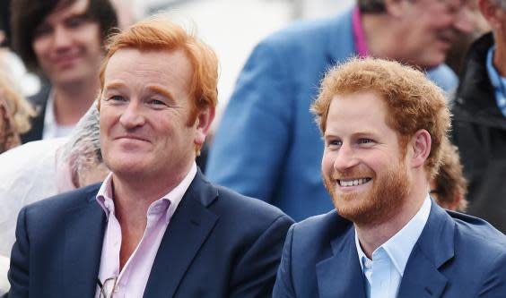 Prince Harry sits with former royal equerry Mark Dyer at the Sentebale Concert at Kensington Palace on 28 June 2016 (Getty Images)