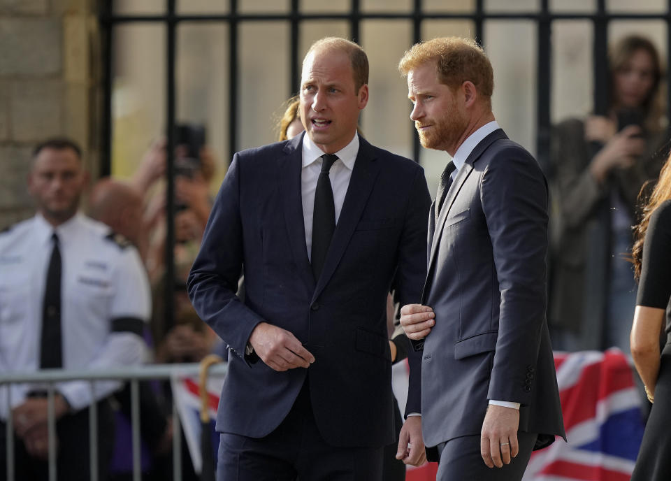 FILE - Britain's Prince William, left, and Britain's Prince Harry speak after viewing the floral tributes for the late Queen Elizabeth II outside Windsor Castle, in Windsor, England on Sept. 10, 2022. Prince Harry flew more than 5,000 miles to see his father after King Charles III was diagnosed with cancer. But he did not see his estranged brother, William, during a visit that lasted scarcely 24 hours. William, meanwhile, returned to public duties for the first time since his wife, Kate, was admitted to a London hospital Jan. 16 for abdominal surgery. (AP Photo/Martin Meissner, File)