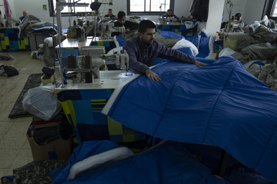 Tailors are producing and preparing mass shipments of sleeping gear for homeless victims of the earthquake in Turkey and Syria now exposed to the freezing winter weather, at a Palestinian factory in the West Bank city of Hebron, Thursday, Feb. 16, 2023. Palestinians have pitched in to help those reeling from the devastating earthquake in Turkey and Syria, with the Palestinian Authority even sending a team of medics and other experts to support Turkish and Syrian rescue efforts. (AP Photo/Nasser Nasser)