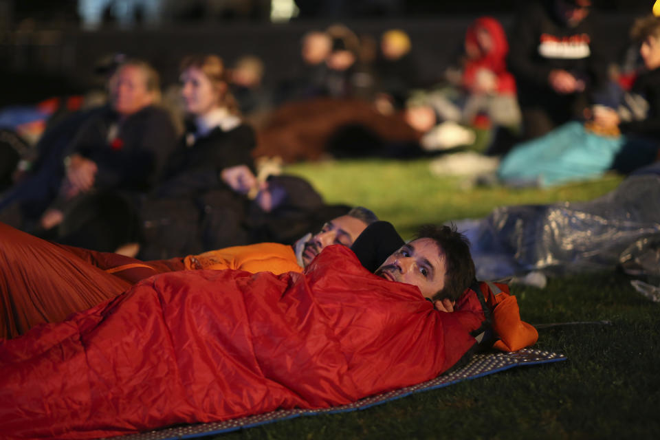 People spend the night before attending the Dawn Service ceremony at the Anzac Cove beach, the site of the April 25, 1915, World War I landing of the ANZACs (Australian and New Zealand Army Corps) on the Gallipoli peninsula, Turkey, early Monday, April 25, 2022. Travelers from Australia and New Zealand joined Turkish and other nations' dignitaries at the former World War I battlefields for a dawn service on Monday to remember troops killed during an unsuccessful British-led campaign that aimed to take the Ottoman Empire out of the war. (AP Photo/Emrah Gurel)