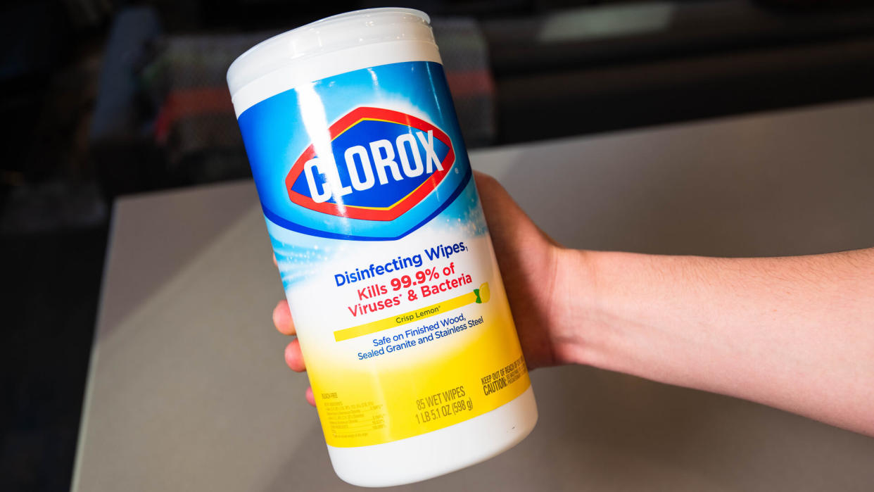 person holding Clorox disinfecting wipes