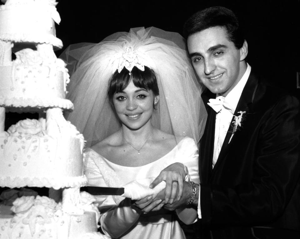 FILE - Newlyweds Diane Sandre, left, and New York Yankees baseball first baseman Joe Pepitone cut their wedding cake molded into the shape of Yankee Stadium at the Holiday Inn in New York, Feb. 1966. Pepitone, a key figure on the 1960s Yankees who gained reknown for his flamboyant personality, has died at age 82. He was living with his daughter Cara Pepitone at her house in Kansas City, Mo., and was found dead Monday, March 13, 2023, according to BJ Pepitone, a son of the former player. (AP Photo/File)