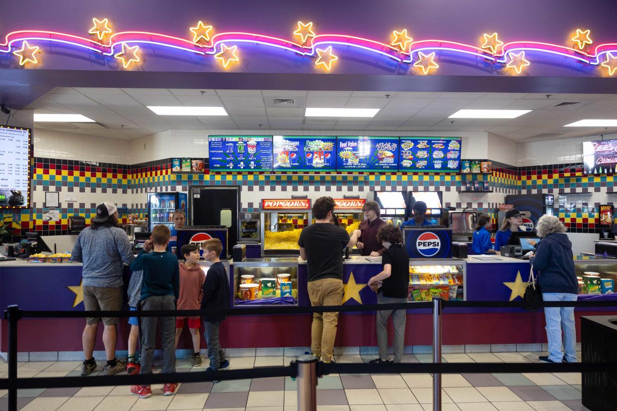 Customers visit the concession stand of the newly opened Atlas Cinemas Barrington 10 on Saturday, April 13, 2024, in Barrington Town Center shopping center in Aurora.