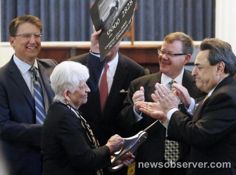 From left, NC Governor Pat McCrory, State Rep. Julia Howard, NC Commerce Secretary John Skvarla III, NC House Speaker Tim Moore, Sen. Bob Rucho participated in a ceremonial cutting up of a federal government credit card at a press announcement Tuesday, May 5, 2015 in the old NC House chamber in the State Capitol. The state announced the complete repayment of its debt to the federal government for unemployment insurance.