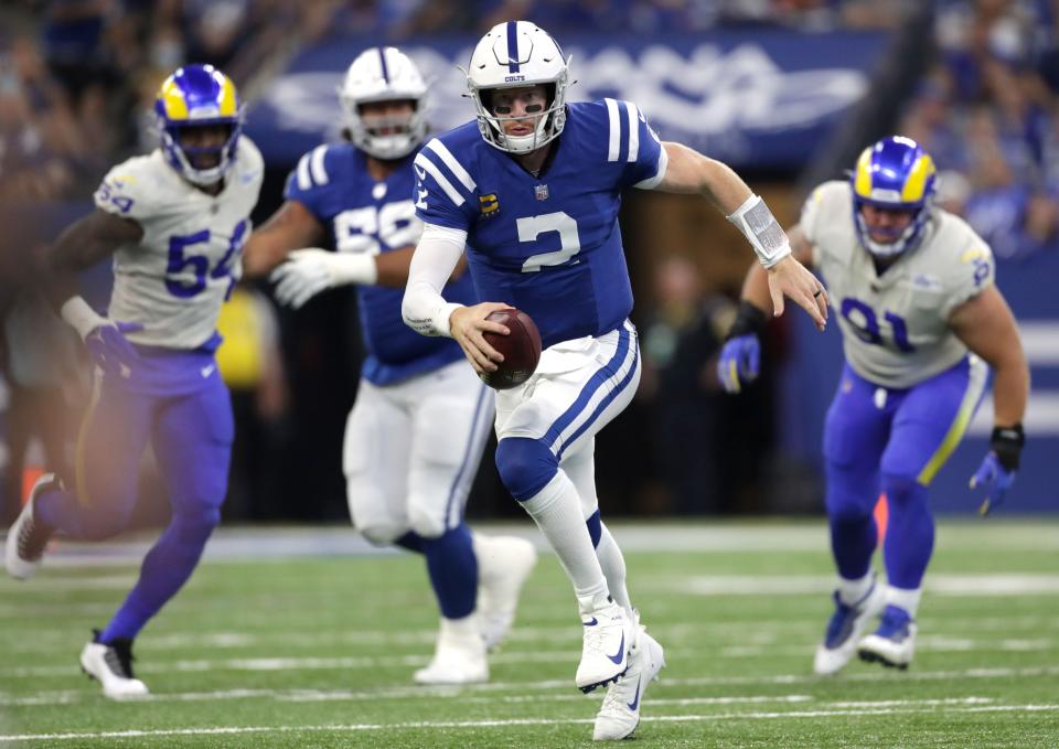 Indianapolis Colts quarterback Carson Wentz (2) scrambles with the ball Sunday, Sept. 19, 2021, during a game against the Los Angeles Rams at Lucas Oil Stadium in Indianapolis.