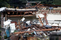 <p>A man stands on a roof and takes photos of a home that was destroyed by explosion in the early morning in the Bronx borough of New York on Sept. 27, 2016. (Carlo Allegri/Reuters) </p>