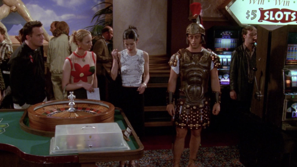 Phoebe, Monica, and Chandler finding Joey at a casino in a Trojan costume