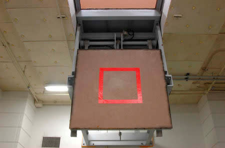 FILE PHOTO : A trap door marked with a red square where an inmate stands, is seen opened at an execution chamber at the Tokyo Detention Center in Tokyo, Japan, in this undated file handout photo released by the Justice Ministry on August 27, 2010. Justice Ministry/Handout via Reuters/File Photo