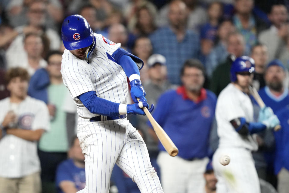 Chicago Cubs' Nico Hoerner hits into an RBI fielder's choice off Pittsburgh Pirates relief pitcher Colin Holderman during the eighth inning of a baseball game, Thursday, Sept. 21, 2023, in Chicago. (AP Photo/Charles Rex Arbogast)