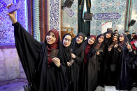 Voters pose for a selfie during the parliament elections at a polling station in Tehran, Iran, Friday, Feb. 21, 2020. Iranians began voting for a new parliament Friday, with turnout seen as a key measure of support for Iran's leadership as sanctions weigh on the economy and isolate the country diplomatically. (AP Photo/Ebrahim Noroozi)