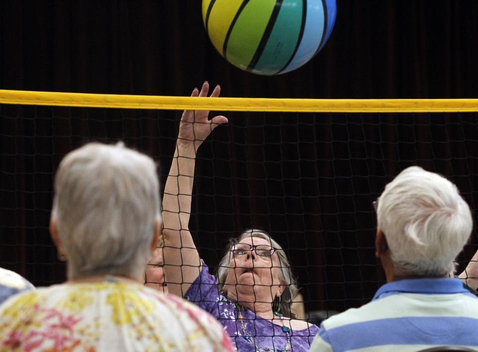 Dotti Hildreth hits the ball during a chair volleyball game May 11.