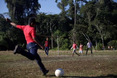 Boys play soccer in Chico Mendes Extraction Reserve in Xapuri, Acre state, Brazil, June 24, 2016. REUTERS/Ricardo Moraes