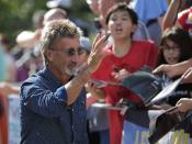 Former race driver Eddie Jordan of Ireland arrives at the track ahead of the third practice session of the Singapore F1 Grand Prix at the Marina Bay street circuit in Singapore September 21, 2013. REUTERS/Tim Chong (SINGAPORE - Tags: SPORT MOTORSPORT F1)