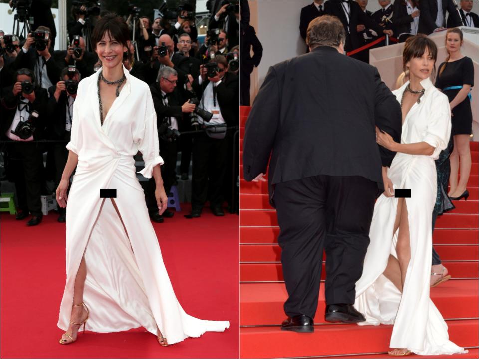 Side by side of Sophie in a white long sleeve wrap gown with a leg slit that exposes her nude underwear on the carpet and walking up the stairs.