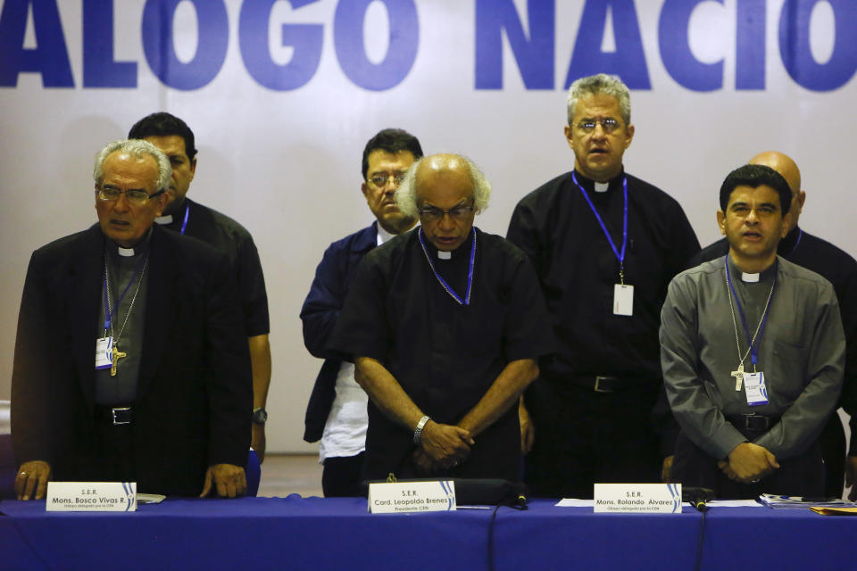 FILE - Bishop Cesar Bosco Vivas Robelo, left, Cardinal Leopoldo Brenes, center, and Bishop Rolando Alvarez, pray at the end of the third day of the national dialogue in Managua, Nicaragua, May 21, 2018. President Daniel Ortega initiallyasked the Catholic Church to play a role as a mediatoras political tensions rose, but the first round ofdialogue didn’t last long. After priests sheltered demonstrators inside their parishes and expressed concern about excessive use of force, Ortegatargeted them as “terrorists”who backed opposition efforts to undermine or overthrow him. (AP Photo/Alfredo Zuniga, File)