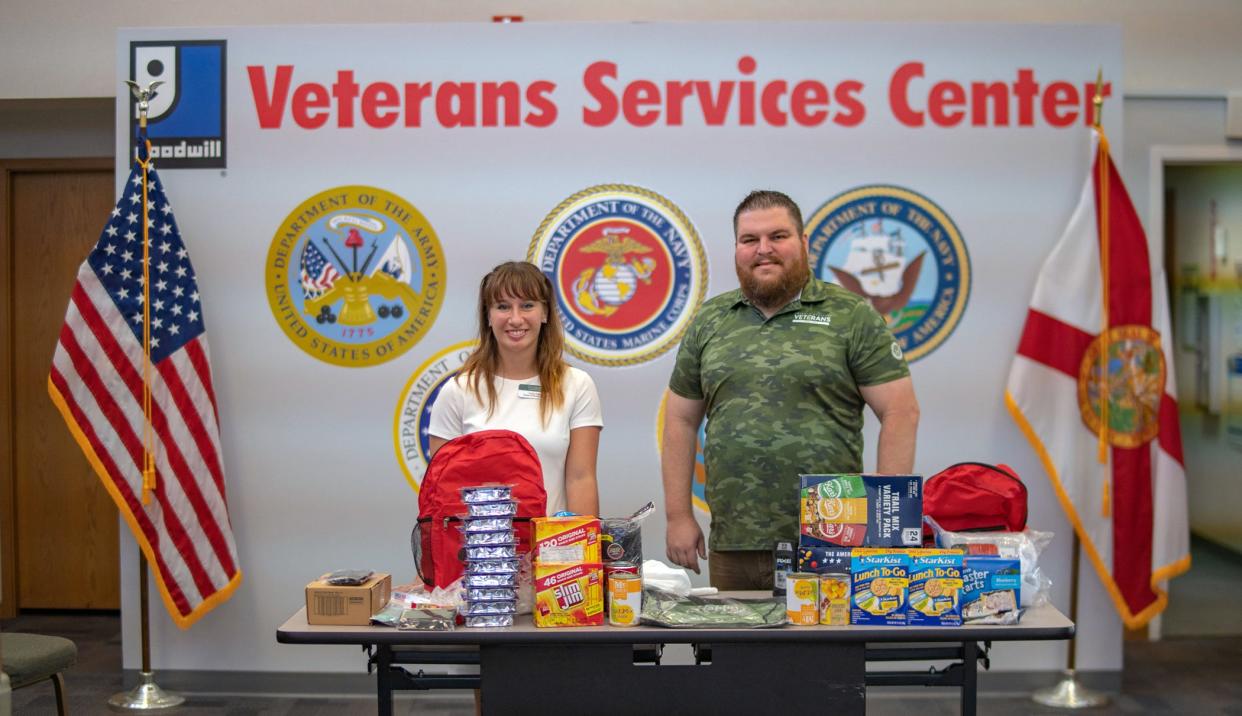 Sydney Pollock, left, director of student services for Everglades University in Sarasota and Todd Hughes, manager of Goodwill’s American Veterans and Their Families program, show donations collected for homeless veterans.