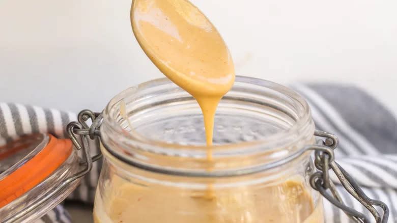 Honey mustard in jar with spoon