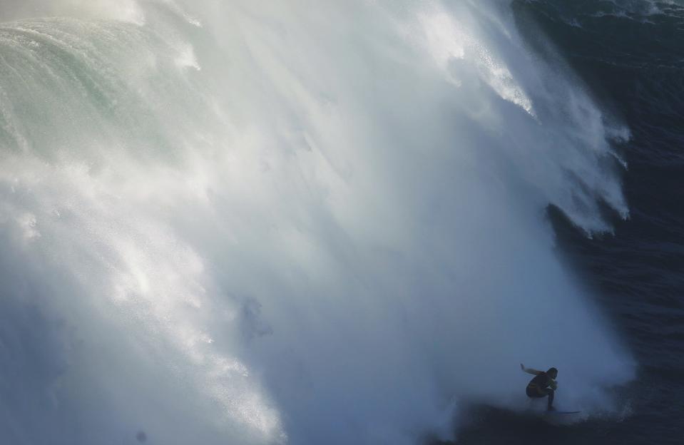 Big-wave surfer Cliff Skudin of US drops in on a large wave at Praia do Norte, in Nazare in this November 29, 2014 file photo. REUTERS/Rafael Marchante/Files (PORTUGAL - Tags: SPORT ENVIRONMENT TPX IMAGES OF THE DAY)