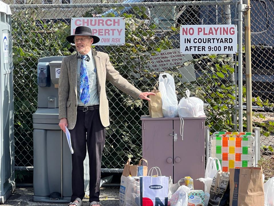 Rev. Bruce MacLeod reestablishes the First Congregation Church of Spencer’s popular food pantry during a service Sunday. The congregation gathered where the church once stood, before a lightning strike sparked a fire that leveled the building.