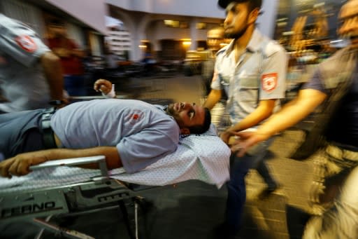 Palestinian paramedics wheel an injured man into the al-Shifa hospital in Gaza City after he was injured by Israeli forces during protests along the border east of Gaza City on July 20, 2018