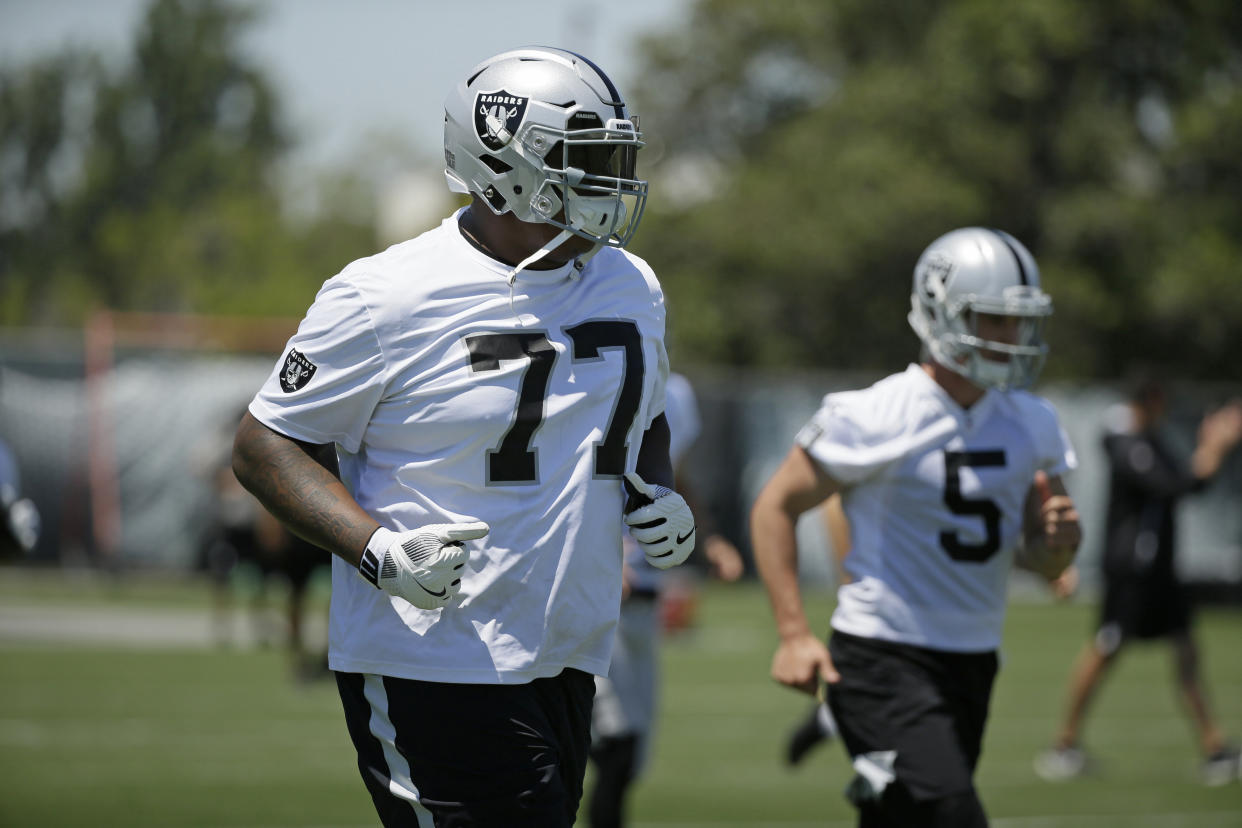 Oakland Raiders offensive tackle Trent Brown (77) and punter Johnny Townsend (5) run during NFL football minicamp Tuesday, June 11, 2019, in Alameda, Calif. (AP Photo/Eric Risberg)
